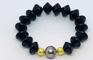 Ebony Saucer and Pearl Bracelet