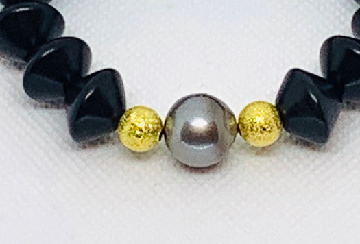 Ebony Saucer and Pearl Bracelet